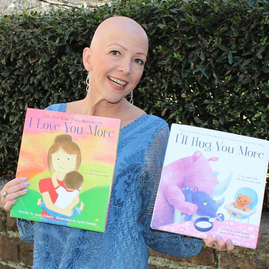 Author Laura Duksta poses with her books 